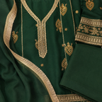 Close up of emerald green girls suit with golden embroidery